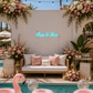 'Miss to Mrs' ice blue neon sign hanging on a wall at a pool party bachelorette with lots of flower arrangements.