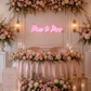 'Miss to Mrs' light pink neon sign hanging on a wall behind a sweetheart table at a pink themed bridal shower with lots of flowers