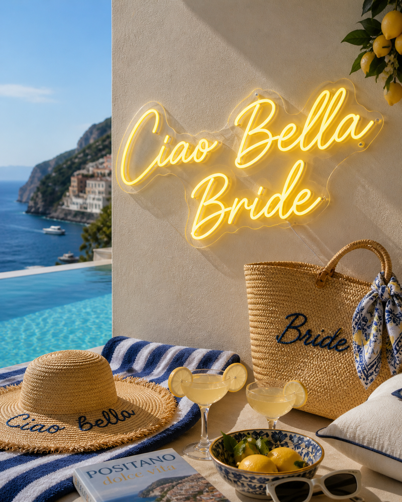 Neon sign 'Ciao Bella Bride' with beach-themed decor by a poolside.