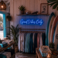 Neon sign 'Good Vibes Only' in a store with clothing racks and surfboards.