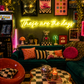 Neon sign that says 'these are the days'  in a retro-themed, maximalist living room with decor elements.