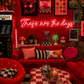 Neon sign that says 'these are the days'  in a retro-themed, maximalist living room with decor elements.